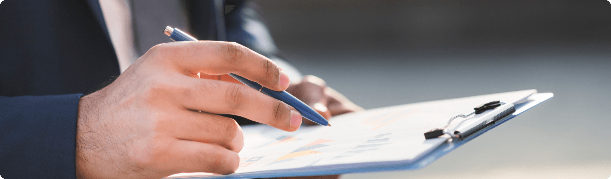 A panoramic landscape with road in the middle surrondded by green fields and blue sky with coulds.
